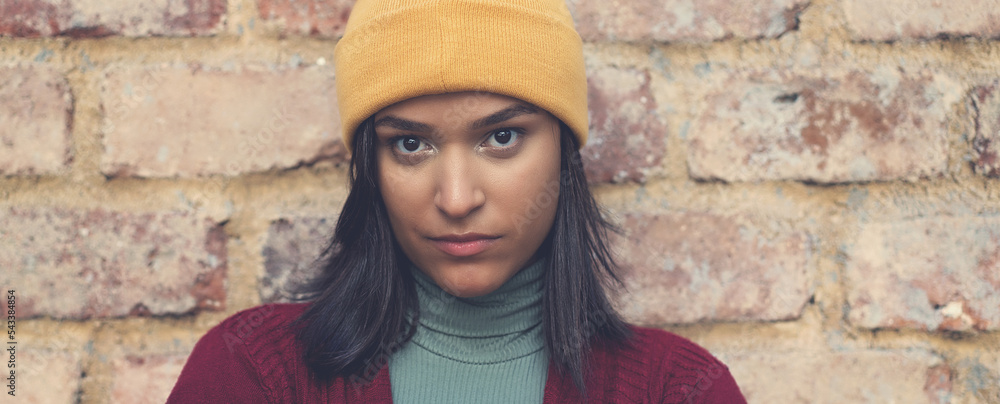 Sad and serious latin american young adult woman with bobble hat Sad and serious latin american young adult woman with bobble hat