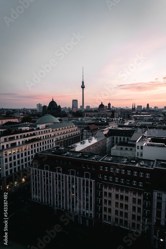 Vertical of TV tower and Berlin downtown under a pink cloudy sky at sunset