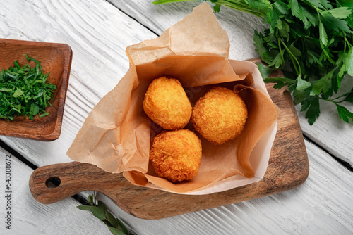 Konstfotografi Fried potato croquettes with cheese on a white wooden background