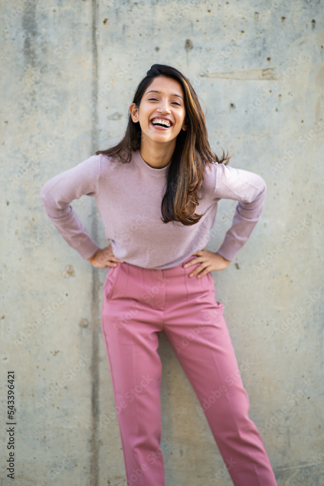 happy young woman laughing with hands on hips happy young woman laughing with hands on hips