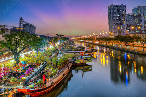 Fotografi Ho Chi Minh City, Vietnam - January 31st, 2022: Flowers boat at market along canal wharf