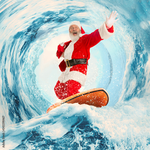 Canvas Print Emotional thrilled Santa Clause surfing on huge wave in ocean or sea