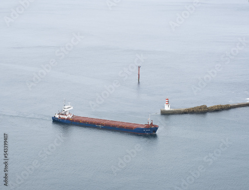 Cargo ship next to the lighthouse in the bay of Pasaia, Euskadi