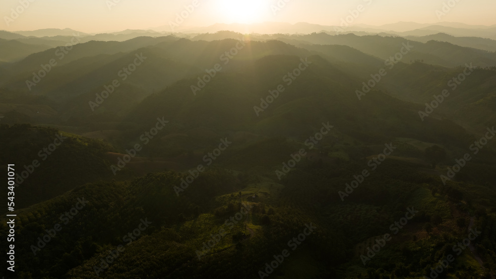 Landscape of mountains layer and forests. The sun rays are shining through the fog. The play of light and shadows. dramatic natural scenery north of thailand. aerial view