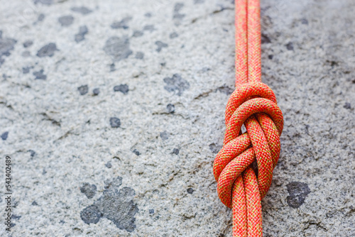eight rope knot on rocky background