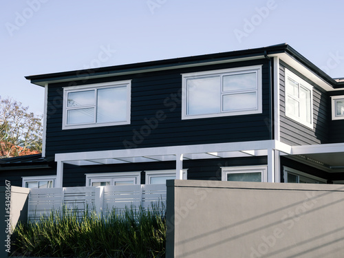 Brand new residential house with black walls and white windows.
