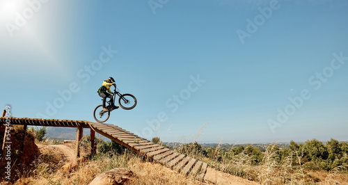 Sports, mountain bike and ramp jump in nature, cycling .and outdoors stunt performance. Fitness, workout and exercise of bmx athlete and racer on bicycle training for competition, race or contest.