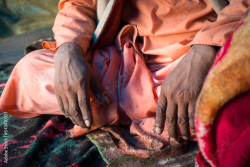 July 14th 2022, Himachal Pradesh India. Closeup of hands of an of an Indian Sadhu in traditional saffron attire during Shri khand Mahadev Kailash Yatra. photo
