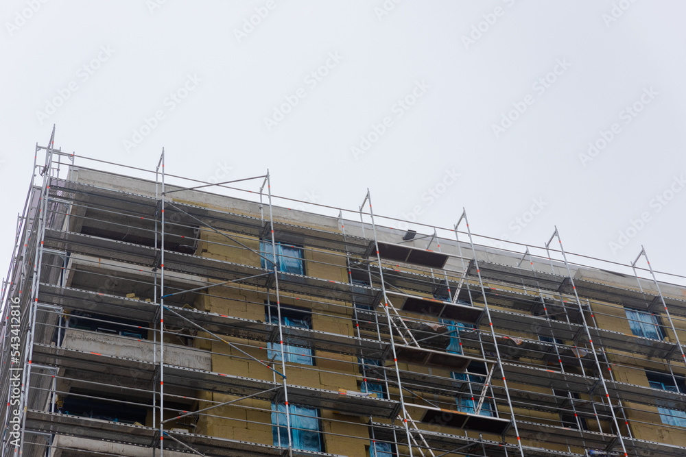 Building apartment building. Placing rock wool insulation on the walls