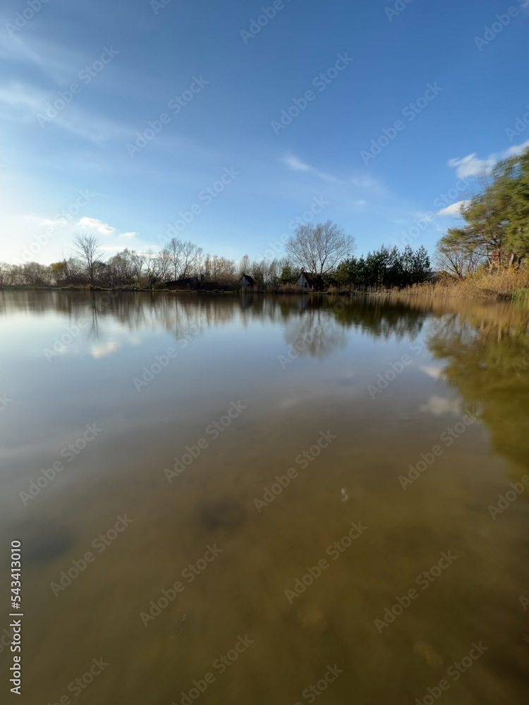 Fototapeta premium Autumn mood landscape with lake and forest in the perfect sunny weather