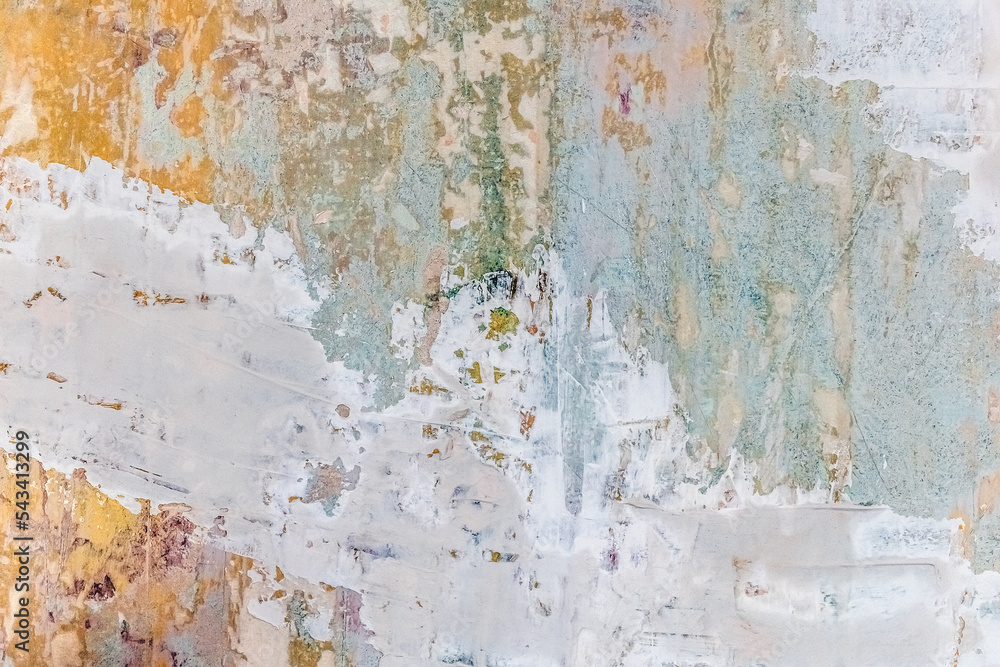 Pastel multicolored layered wall texture with layers of paint, plaster and putty. Blue-green-yellow-pink abstract grunge vintage real architecture pattern