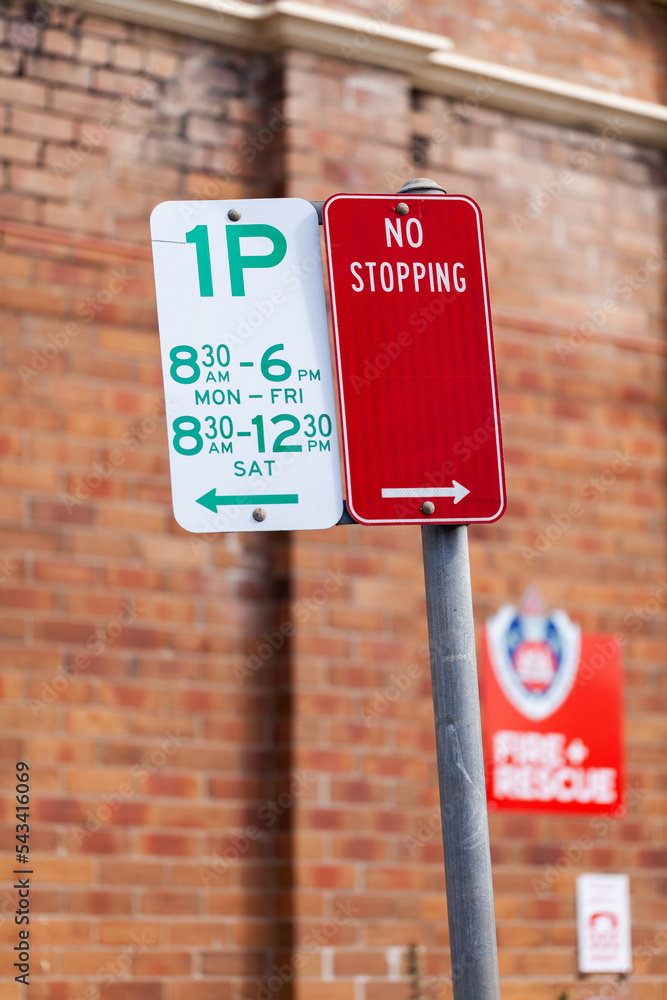 one hour parking and no stopping warning street sign near fire and rescue station one hour parking and no stopping warning street sign near fire and rescue station