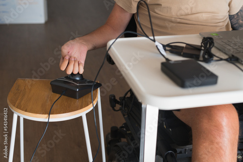 disabled man using computer, with special adaptive devices photo