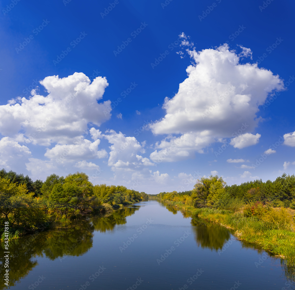 quiet irrigational channel under blue cloudy sky