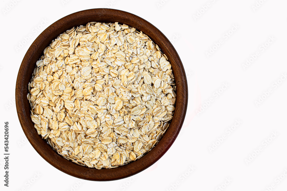 Close-up oats flakes in a wooden bowl Close-up oats flakes in a wooden bowl