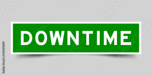 Sticker label with word downtime in green color on gray background