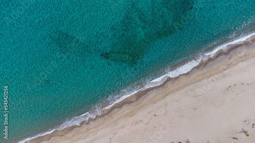 Aerial top view of Livadi Beach at the Ikaria island in a quiet summer day with blue clear water photo