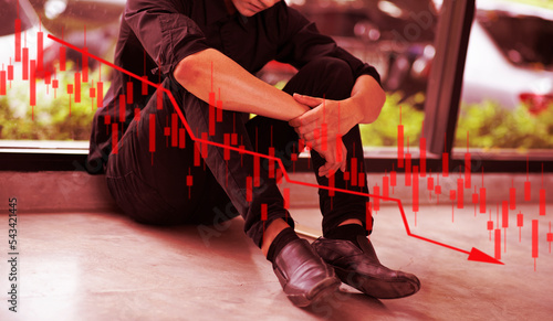 Red theme stressed business man shocked by bankruptcy stock downfall financial crisis, line graphs bar chart and candlesticks go down. Stock market falls.