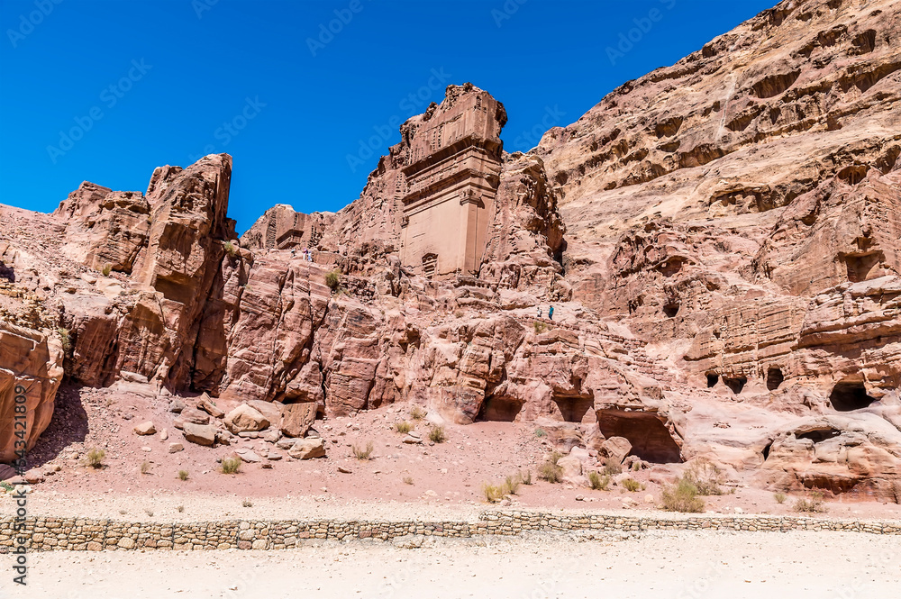 A view of temples carved into rock hillsides in the ancient city of Petra, Jordan in summertime A view of temples carved into rock hillsides in the ancient city of Petra, Jordan in summertime