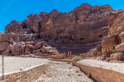 A view up a water channel towards the ruins of the ampitheatre in the ancient city of Petra, Jordan in summertime photo