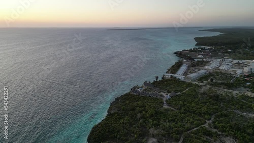 Hotel resorts at Kusini beach Zanzibar Island Tanzania Africa with sunset over ocean, Aerial pan left reveal shot photo