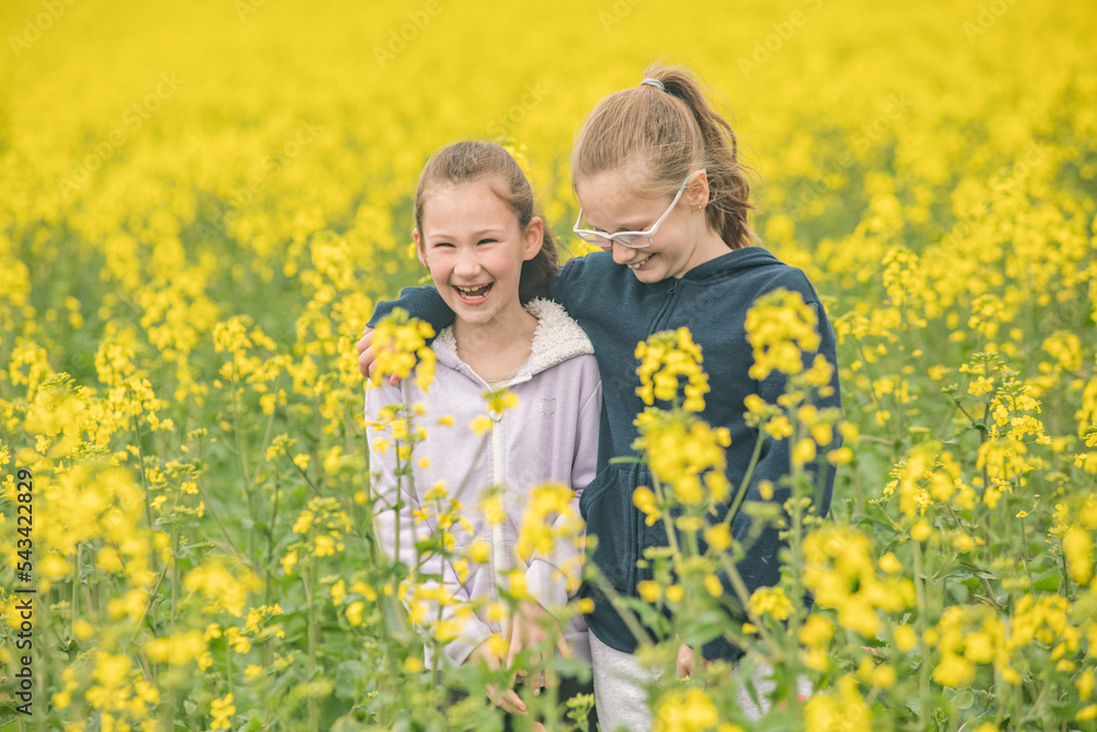 Two young sisters hanging out in their family canola field. Two young sisters hanging out in their family canola field.