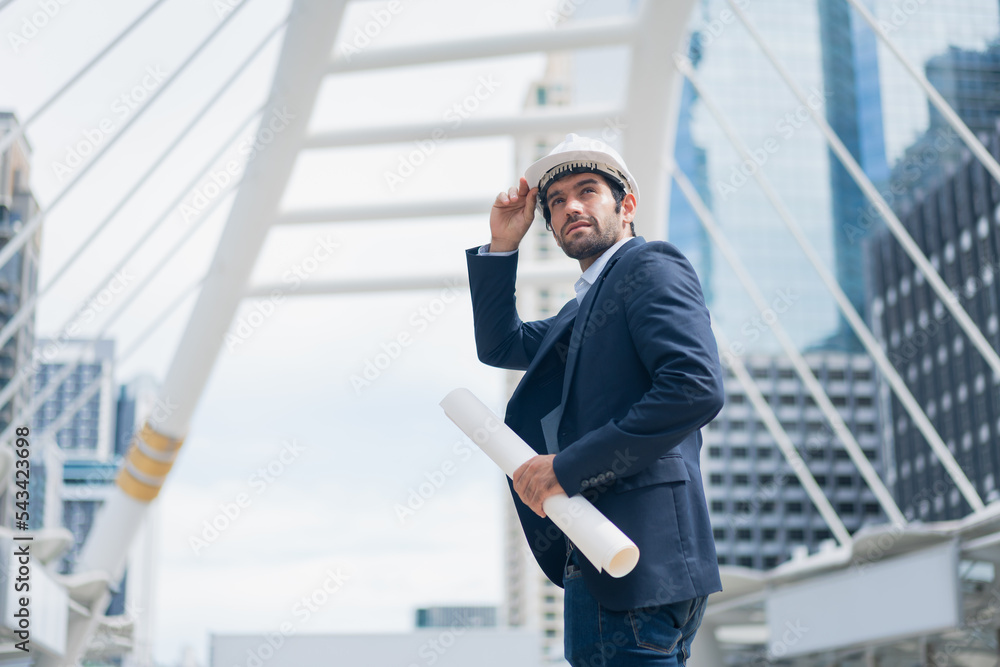 Man engineer standing on construction site. Engineer working on outdoor project Man engineer standing on construction site. Engineer working on outdoor project