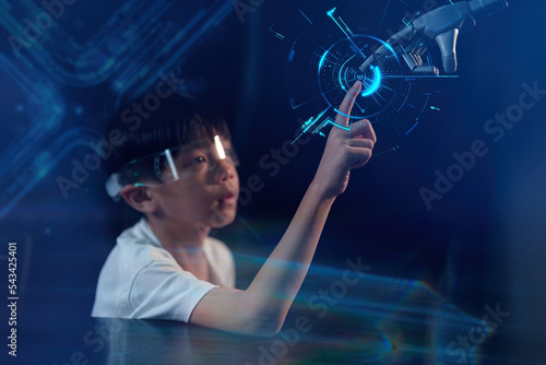 Portrait Boy holding his finger to touch robotics arm finger for STEM concept interacting with a cyborg ,Humanoid robot finger and children finger meets in front of blackboard