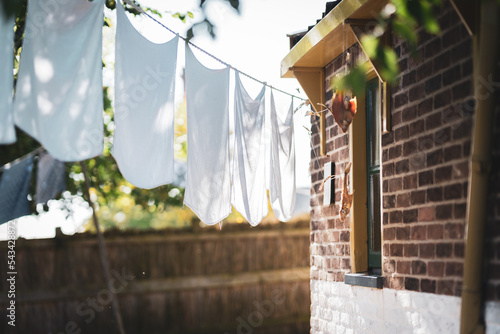 White laundry hangs to dry at a vintage workers' cottage in a small dutch village