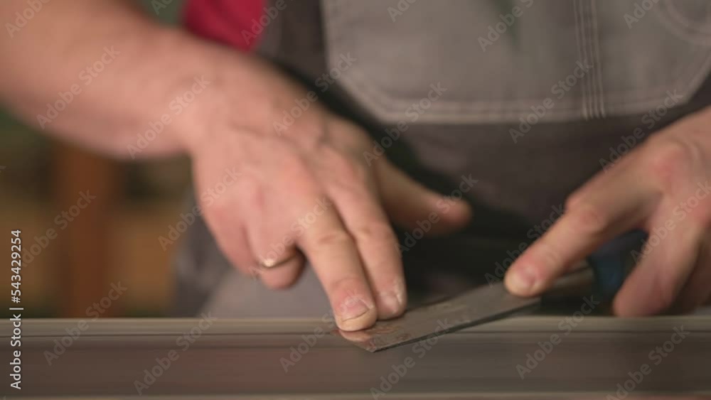 a man sharpens a chisel on a specialized machine. live video a man sharpens a chisel on a specialized machine. live video