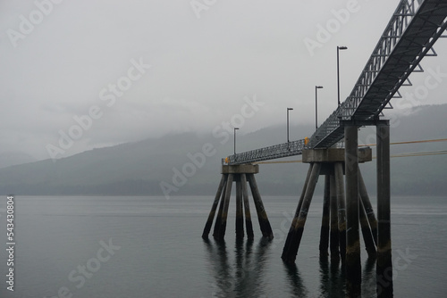 Hoonah, Alaska: An unoccupied cruise ship dock in the waters of Port Frederick, on a foggy summer morning. photo