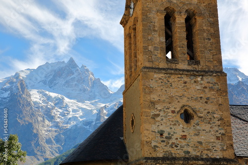 The Meije Peak viewed from Le Chazelet village in Ecrins National Park, Romanche Valley, Hautes Alpes (French Southern Alps), France, with the bell tower of the church in the foreground photo