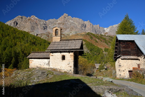 Fontcouverte hamlet located in Vallee de la Claree (Claree Valley) above Nevache village, Hautes Alpes (French Southern Alps), France, with a chapel and traditional wooden chalets (mountain huts) photo