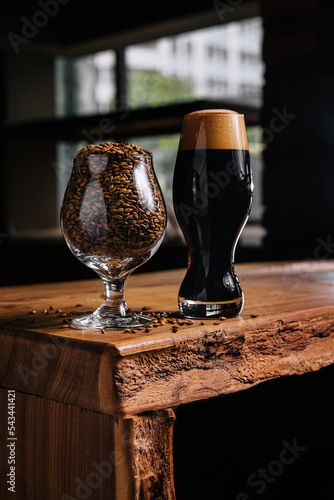 tasty dark beer and glass of wheat on wooden