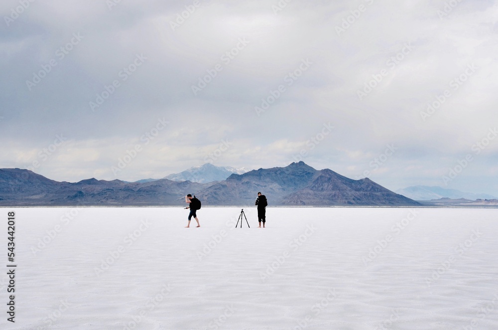 Special Recreation Management Area, the Bonneville Salt Flats of a densely packed salt pan in Utah. Two photographers on site shooting photos 
