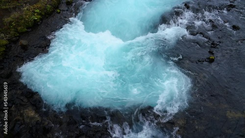 Splashing blue colored water of Bruara River in Iceland - top view photo