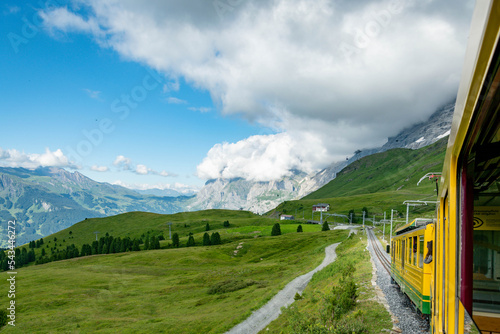 Swiss Alps with train. Beutifull trainride in the Alps. Train with beutifull view and landscape full of mountines. Railway into the mountines in Switzerland. photo