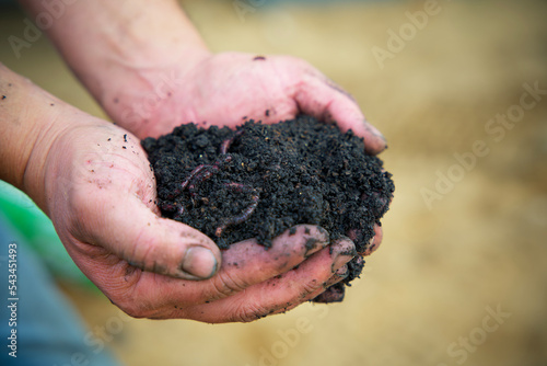 close up of two hands full of black soil