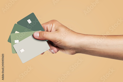 Man's hand holding credit cards.