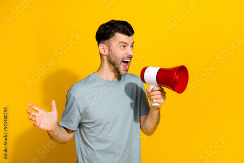 Profile side photo of crazy angry man look empty space shouting employee dissatisfied results isolated on yellow color background photo