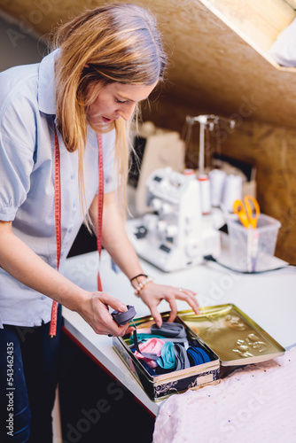 Bilde på lerret Seamstress dressmaker woman working with fabric in sewing workshop