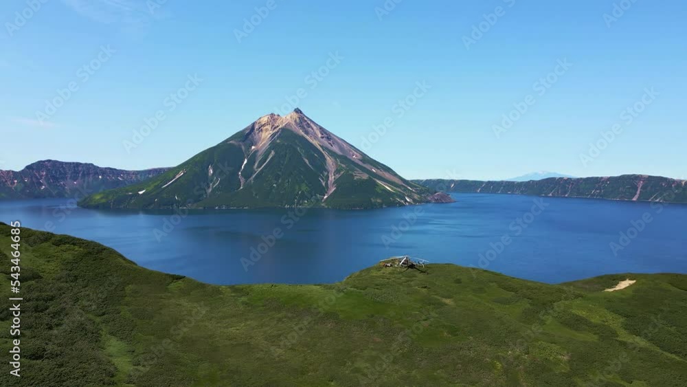 AERIAL Helicopter standing on the edge of Krenitsyn volcano. Onecotan island AERIAL Helicopter standing on the edge of Krenitsyn volcano. Onecotan island