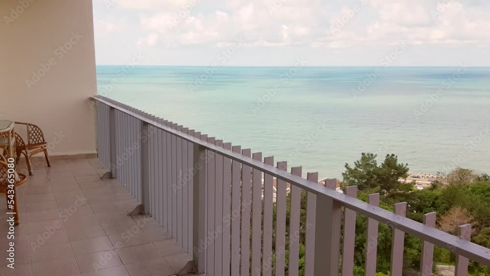 4k video, wicker furniture on a large balcony with metal railings, sea and sky view with clouds. 4k video, wicker furniture on a large balcony with metal railings, sea and sky view with clouds.
