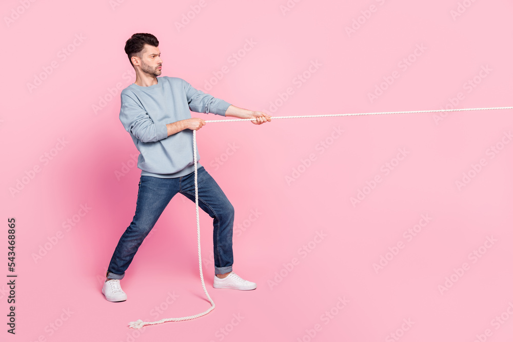 Profile side full body photo of guy pulling string have victory
