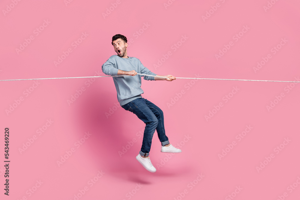 Profile side full length photo of guy jump pulling string look back ...
