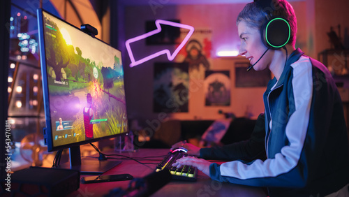 Hyped Female Gamer Playing PvP 3D Shooter Video Game in Which Players Fight in a Tournament on Her Personal Computer. Room and PC with Neon Lights. Stylish Young Woman in Cozy Room at Home.