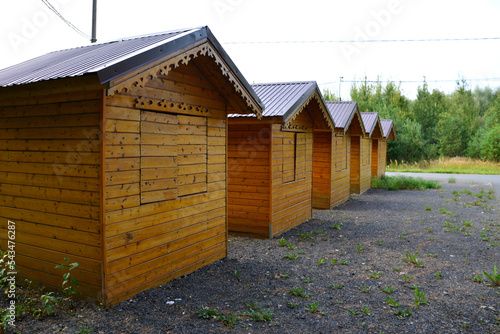 wooden cottages in forest camping in a row isolated, close-up