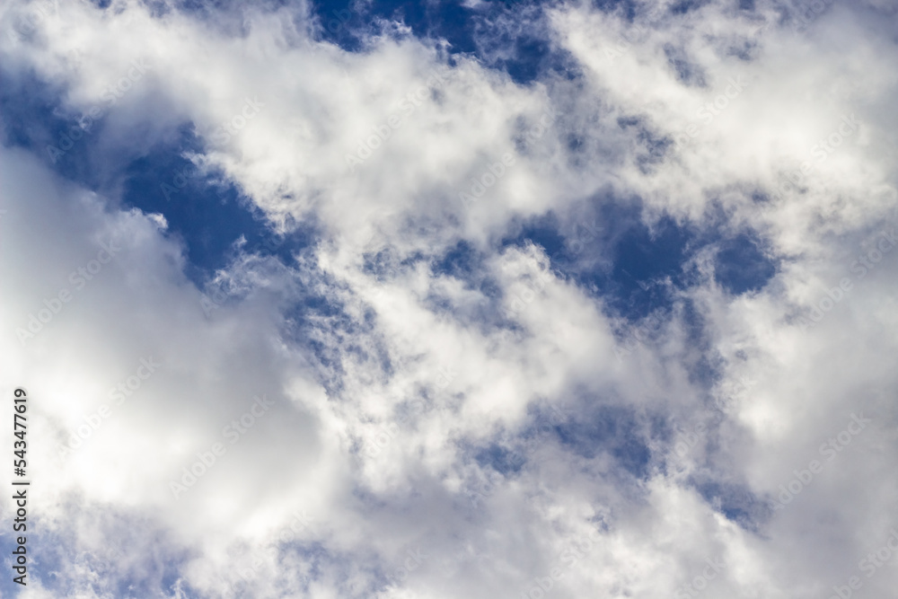 Fototapeta premium Beautiful blue sky background with cumulus clouds. Sunlight.
