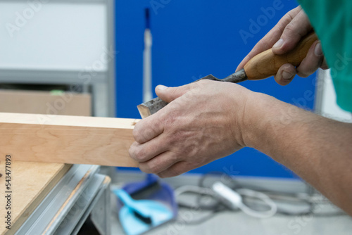 close up of a man working on a wooden board