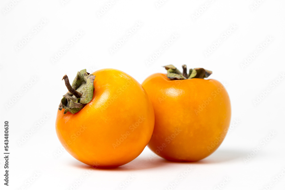 Persimmon on a white background. Ripe and tasty fruit Persimmon on a white background. Ripe and tasty fruit